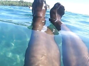 stocking and red toes in the sea