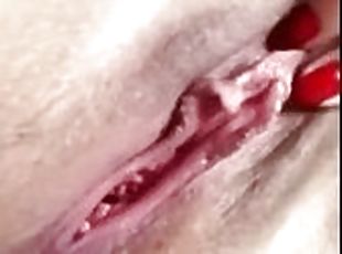 Caressing the pussy with fingers causes a flow of white cum from the pussy, a woman's wet orgasm.